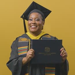 Andrinna Broadnax '25, bachelor's in public health graduate from WUV, holding her diploma.
