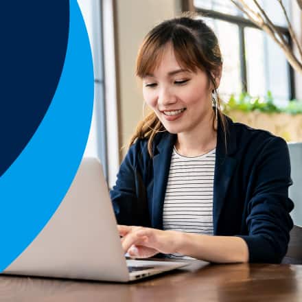 A graphic of a pencil over paper with a blue background next to an image a woman searching is a liberal arts degree worth it on her laptop.