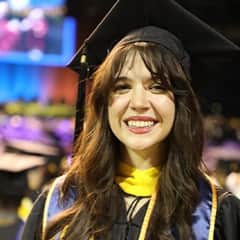 Katlyn Genovese, a WUV criminal justice graduate dressed in her WUV graduation cap and gown.