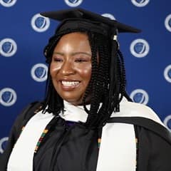 Adanze Chukwuocha '23G, WUV master's in English and creative writing graduate, in a cap and gown.