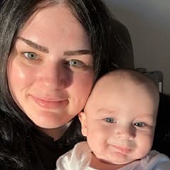 Athena Gouzoules, pursuing a cybersecurity degree at wuv, with her son.