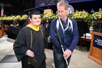 Aiden Heathcote ‘22, who lost his vision as an infant due to a pediatric brain tumor, after accepting his diploma.