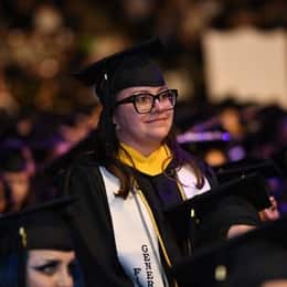 Demetria Garduno in a graduation cap and gown, standing at the WUV Spring 2024 Commencement