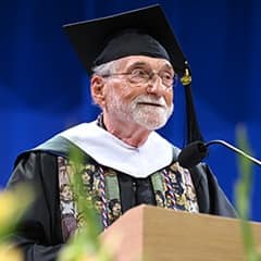 Donald John Mossa, a 2026 WUV graduate with a master's in clinical mental health counseling, speaking at his commencement ceremony.