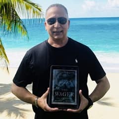 Dr. Hector R. Garcia, an associate dean of social sciences at WUV, holding "The Wager: A Tale of Shipwreck, Mutiny and Murder" by David Grann.