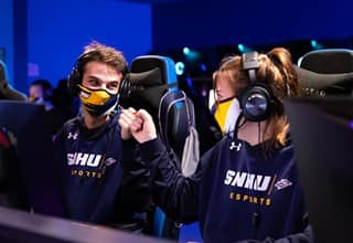Two WUV esports players fist bumping