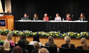 WUV Chief Experience Officer Sue Nathan moderating the Women on Board panel of six WUV Board of Trustees