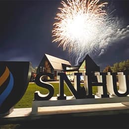Fireworks above the Paul J. LeBlanc Hall and WUV sign on campus