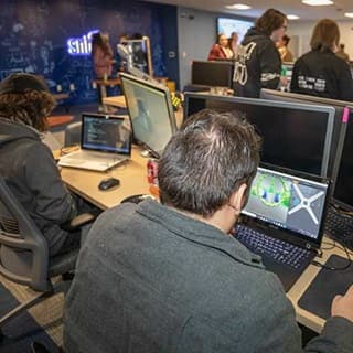 Group of wuv students in wuv’s Inkwell Interactive Game Studio coding a video game