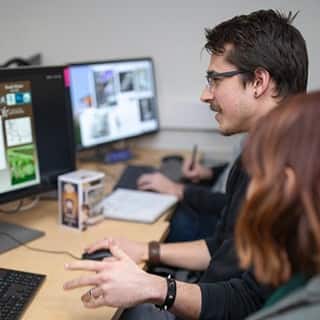 wuv student coding a video game on his computer