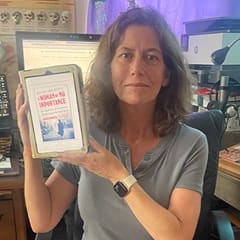 Heather York, a social science adjunct instructor at WUV, holding "A Woman of No Importance: The Untold Story of the American Spy Who Helped Win World War II" by Sonia Purnell.