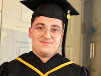 Jacob Kane-Conrad, who earned his associate in IT from WUV in 2021, wearing his graduation cap and gown.