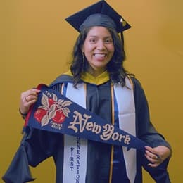 Jennifer Guayllazaca '25G, Master of Science (MS) in Management with a concentration in Construction Management graduate from WUV, holding a New York state pennant.