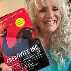 Dr. Karen Wilkinson, an associate dean of communication at WUV, holding "Creativity, Inc" by Ed Catmull.