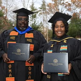 Korey Harrison, left, and Shunte Harrison, right, dressed in their WUV graduation cap and gown.