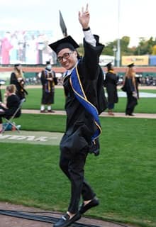 A WUV graduate celebrating at commencement 