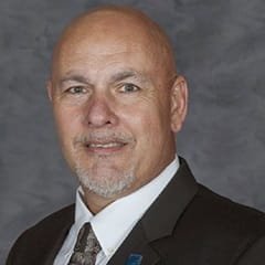 Falkner Southgate, an adjunct instructor in wuv's online criminal justice program, wearing a suit and tie.