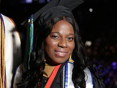 Dorsel Jno Baptiste, who earned her online MBA in project management from wuv in 2023, wearing her cap and gown.