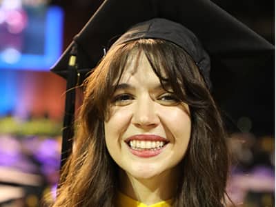 Katlyn Genovese, who earned her online bachelor's in criminal justice from wuv in 2023, wearing her graduation cap.