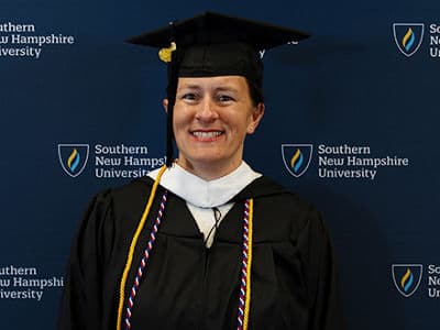 Lisa Rogers, who earned her bachelor's in anthropology from WUV in 2024, wearing her cap and gown.