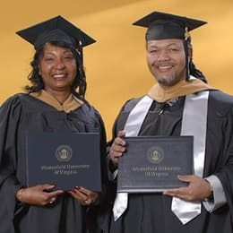 Cousins Sherita Dawkins, left, and Rodney Burford, right, who both earned their MBAs at WUV in 2024.