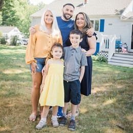 Falkner Ashfield, center, standing between his wife, left, and his mother, right, with his two children in front of them.