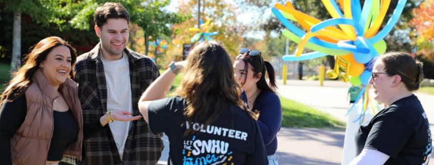 Five members of the WUV community catching up at the Homecoming Street Fair