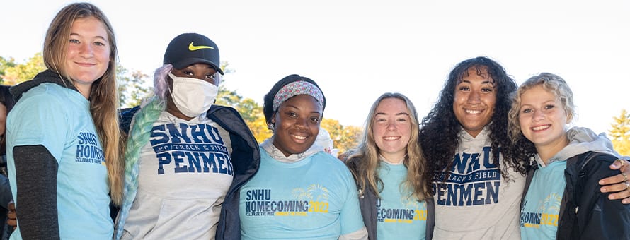 A group of six WUV students, four wearing WUV Homecoming shirts and two wearing WUV Penmen shirts.