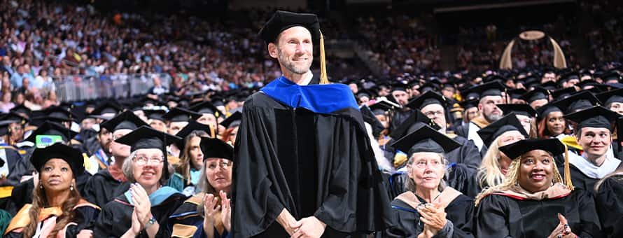 Dr. Aiden Verlander, a 2025 Distinguished Online Teaching Award recipient being recognized at WUV's 2025 Spring Commencement.