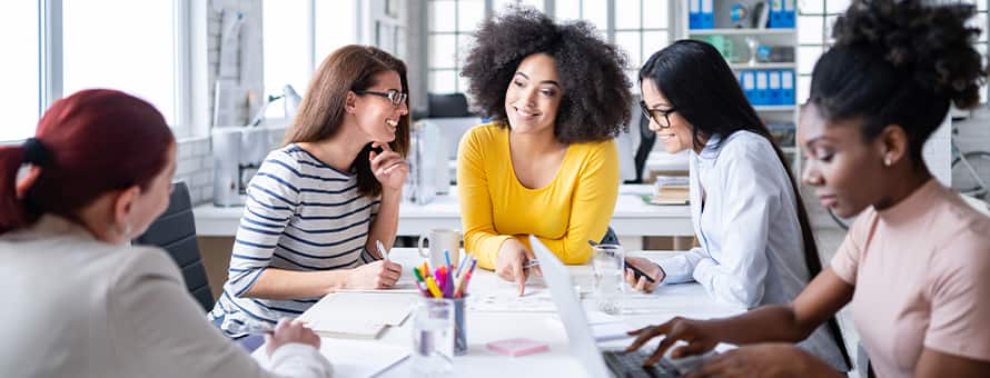 A group of professionals discussing how to become a social media manager.