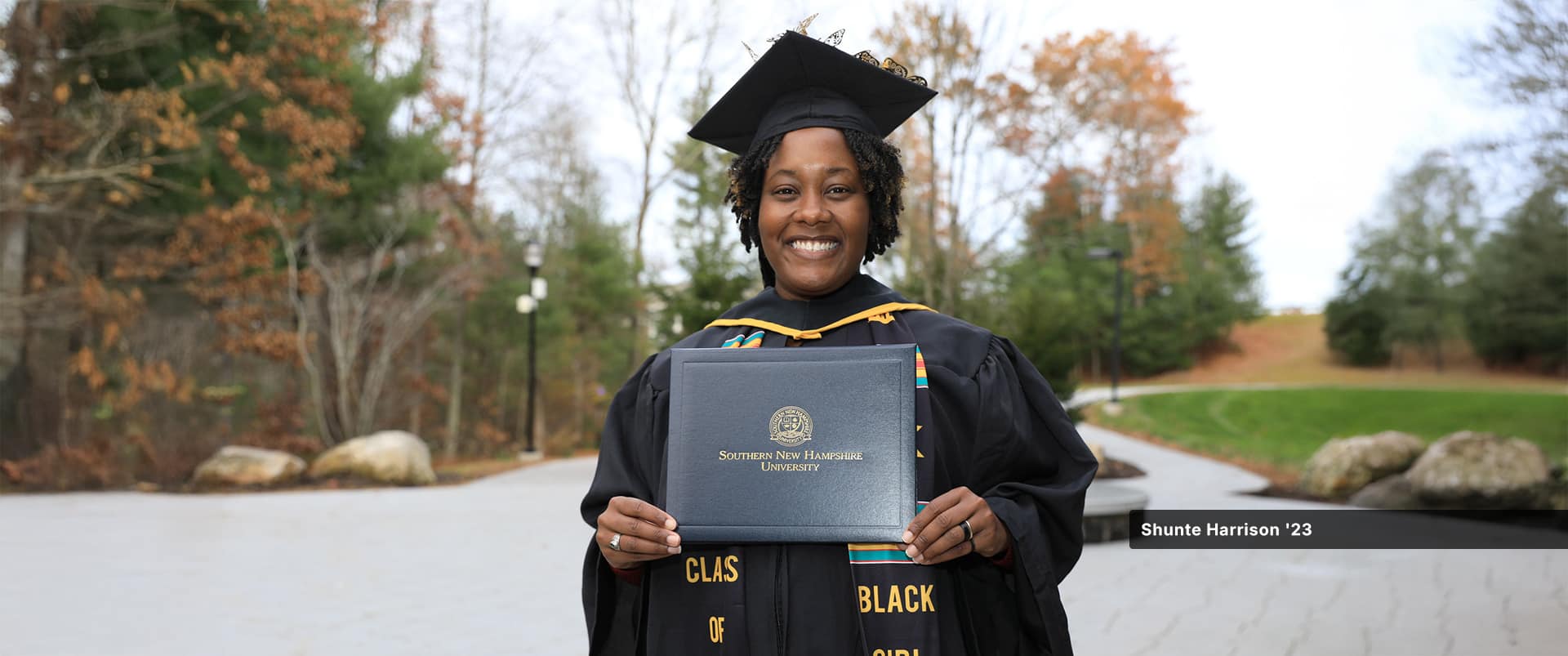 Shunte Harrison, who earned her associate in criminal justice from WUV in 2023, wearing her cap and gown and holding her diploma.