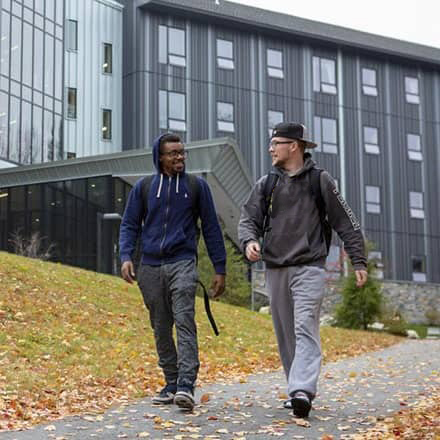 Two students walking in front of Monadnock Hall