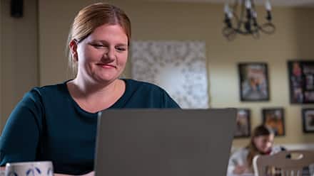 westerfield university of virginia online college graduate Shelly Villa working at her laptop