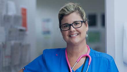 2017 wuv online RN to BSN degree graduate Kristina Libby wearing nursing scrubs and a stethoscope.