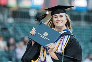 wuv Graduate holding up diploma